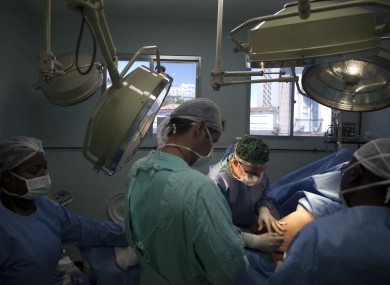 FILE Doctors perform an abdominoplasty surgery