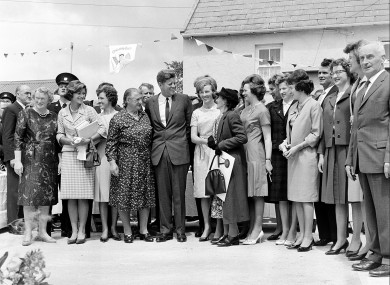 During his three-day visit to Ireland, U.S. President John F. Kennedy meets with his Irish cousins in the barnyard of their mutual forefather's homestead, at Dunganstown, June 27, 1963.