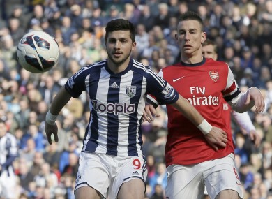 West Bromwich Albion's Shane Long, shields the ball from Arsenal's Laurent Koscielny during their English Premier league soccer match.