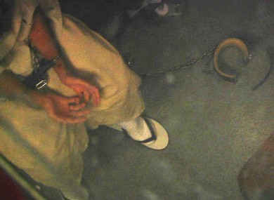 In this April 16, 2013 video frame grab reviewed by the U.S. military, a shackled detainee meets with medical personnel in Camp 6, at Guantanamo Bay Naval Base, in Cuba.
