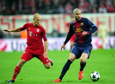 Bayern Munich's Arjen Robben (left) and Barcelona's Gerard Pique battle for the ball.