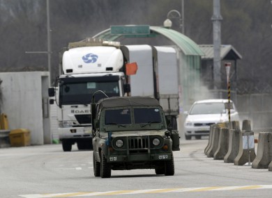 South Korean vehicles returning home from North Korea's Kaesong complex are escorted by a South Korean military.