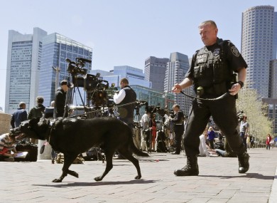 A Department of Homeland Security police officer patrols with his dog outside the Moakley Federal Courthouse in Boston, Mass., Wednesday, May 1, 2013.