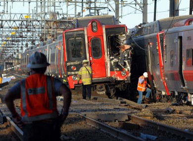Emergency personnel work at the scene where two Metro North commuter trains collided.
