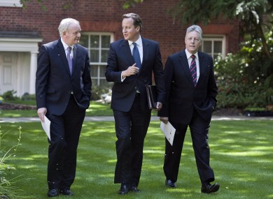 Prime Minister David Cameron walks with Northern Ireland's Deputy First Minister Martin McGuinness and Northern Ireland's First Minister Peter Robinson earlier in the garden of 10 Downing Street in central London.