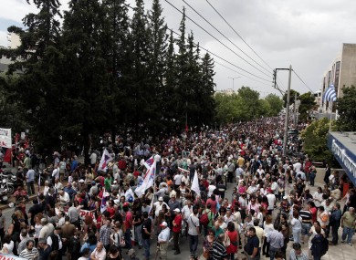 Thousands of protesters take part in a rally outside the Greek state television ERT headquarters during a 24-hour general strike in Athens today.