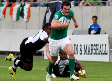 Tom Daly makes a break for Ireland.