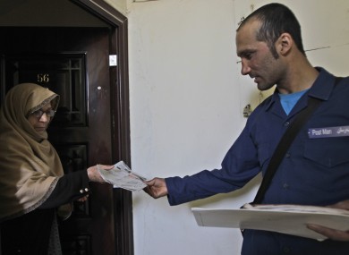 An Afghan postman delivering a letter in Kabul in 2011.
