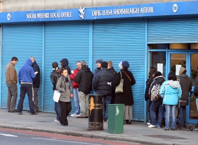 File pictures show people queuing at a Social Welfare office
