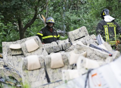 Firefighters assess the aftermath of the crash