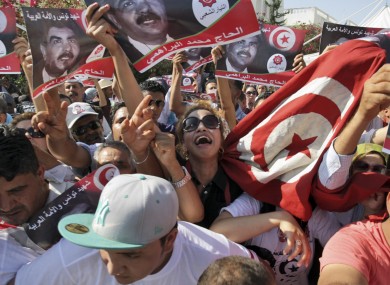 Tunisians react as the coffin of Tunisian opposition politician Mohammed Brahmi is carried out of his home in El Ghazela.