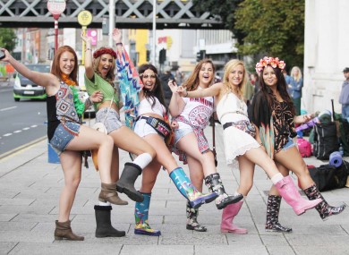 Girls from Donabate queue up to buy tickets before leaving for Electric Picnic at Custom House Quay in Dublin city on buses.