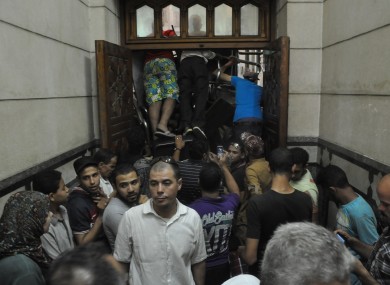 Pro-Muslim Brotherhood supporters shove furniture against the doors to stop anyone from breaking into the mosque.