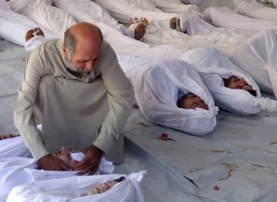 Citizen journalism image, which has been authenticated based on its contents and other AP reporting, a Syrian man mourns over a dead body after an alleged poisonous gas attack in Douma town, Damascus.