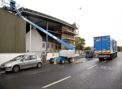 The old school being encased by the Glanbia structure in Ballitore, Co. Kildare. The building is due to be demolished this weekend.