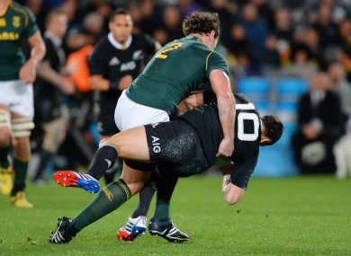 South Africa's Bismarck Du Plessis tackles Daniel Carter of the All Blacks.