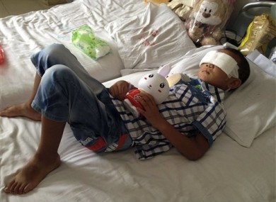 Guo Bin lies on a bed in a hospital as he recuperates from the attack in the rural area of Linfen city