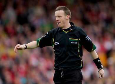 Man in the middle: Referee Joe McQuillan.