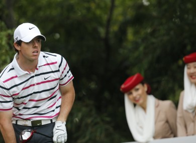 Mcllory watches his tee shot on the eighth hole during the first round of the HSBC Champions golf tournament at the Sheshan International Golf Club in Shanghai.