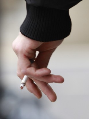 A pedestrian smokes in the pedestrian plaza near Times Square in New York