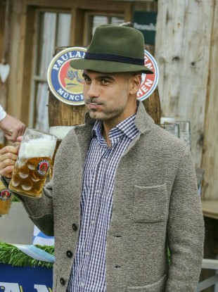 Guardiola enjoys a beer with his team.