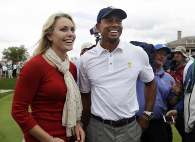 United States team player Tiger Woods smiles with girlfriend Lindsey Vonn after US won the Presidents Cup golf tournament.