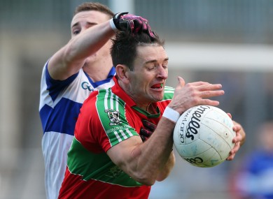 Ballymun's Derek Byrne tackled by Jarlath Curley of St Vincent's.
