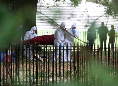 The body of the man is removed from where it was found on fire near the Wellington Monument in Phoenix Park, Dublin.