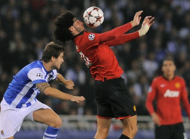 Manchester United's Marouane Fellaini duel for the ball with Real Sociedad's Inigo Martinez.