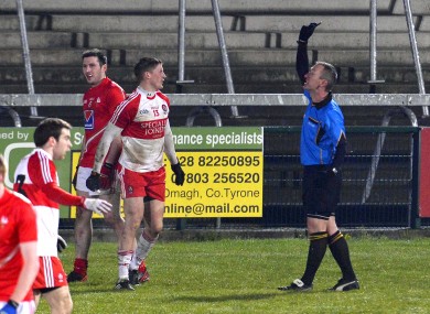Derry's Declan Mullan becomes the first player to be shown the black card by referee Brendan Rice.