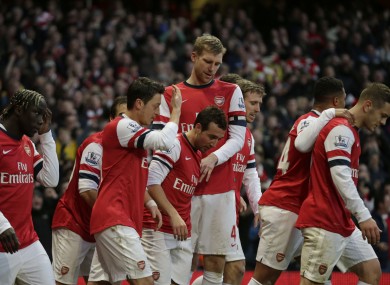 Arsenal's Santi Cazorla, centre, celebrates scoring his side's first goal with his teammates.
