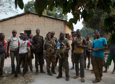 Anti-balaka militiamen stand together as they talk to journalists