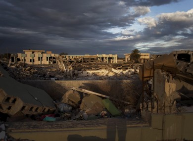 File: Buildings destroyed in the Bab al-Aziziya compound and an occupied intact building in Tripoli, Libya.