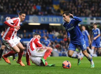 Eden Hazard goes past two Stoke defenders.