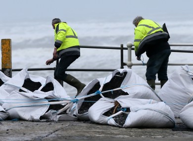 Workers battling the elements to get storm defences in place at Lahinch, Co Clare earlier this month.