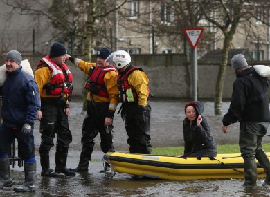 Residents use a boat to navigate flood waters after a flash flood on the Lee Estate in Limerick City last weekend.