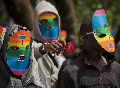 Kenyan gays and lesbians and others supporting their cause wear masks to preserve their anonymity in a protest against the Ugandan laws.