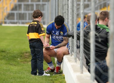 Galvin signs an autograph for one of his young fans, Ryan Neeson.