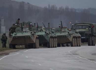 Russian armored personnel carriers and a truck are parked on the side of the road near the town of Bakhchisarai, Ukraine.