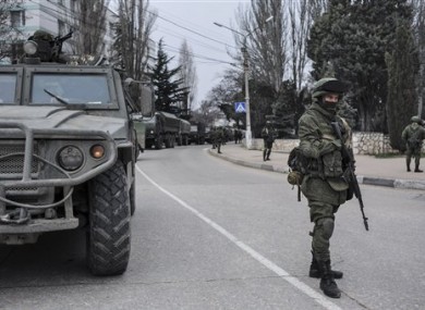 Troops in unmarked uniforms stand guard in Balaklava on the outskirts of Sevastopol, Ukraine today.