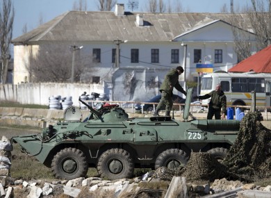 Pro-Russian soldiers in unmarked uniforms with an APC, pictured yesterday near Ukrainian marines base in the city of Feodosia, Crimea.
