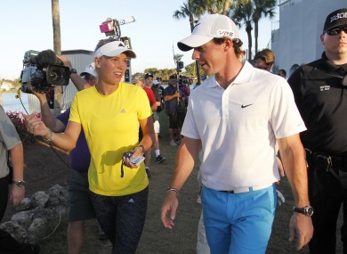 Rory McIlroy walks with his fiancee, tennis player Caroline Wozniacki, after finishing his third round at the Honda Classic