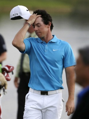 Rory McIlroy walks off the 18th green after losing in the four-man playoff in the final round of the Honda Classic golf tournament.