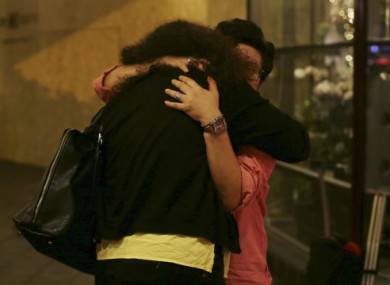 A woman is comforted as she breaks into tears during memorial cermony in Kuala Lumpur, Malaysia.