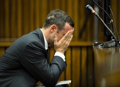 Oscar Pistorius cradles his head in his hands in court on the fifth day of his trial at the high court in Pretoria.