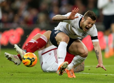 Jack Wilshere is challenged by Denmark's Daniel Agger last night.