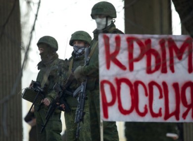 Unidentified gunmen wearing camouflage uniforms block the entrance of the Crimean Parliament building in Simferopol, Ukraine
