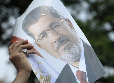 A protester hold a photograph of ousted president Mohammed Morsi