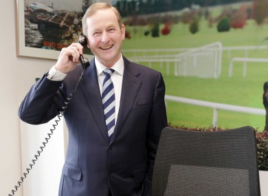 The Taoiseach takes a call at the new Ryanair office in Dublin on Thursday.