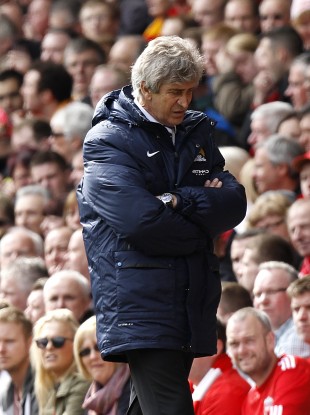 Manchester City manager Manuel Pellegrini looks dejected on the touchline.